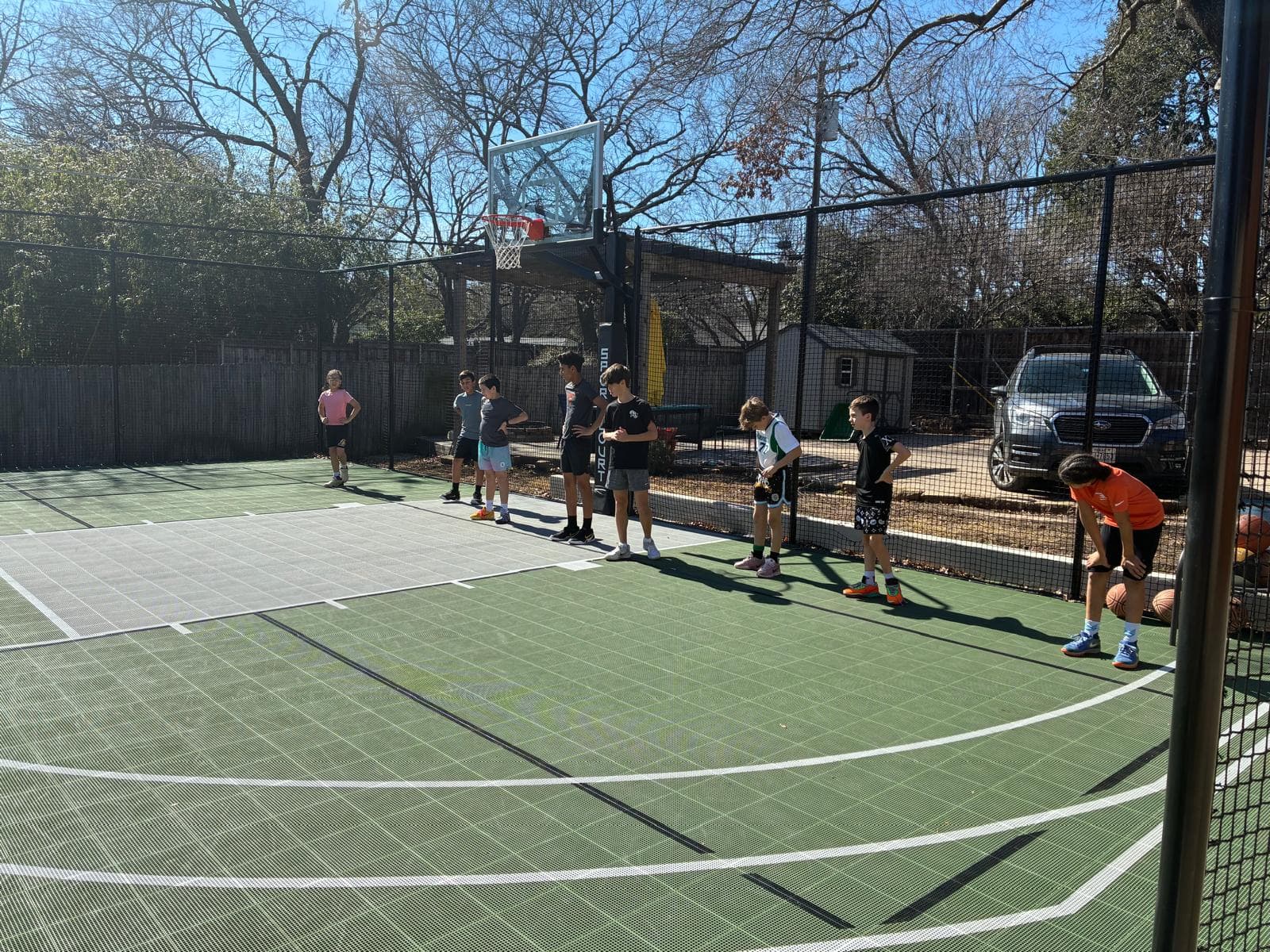 Kids lined up for training drills on Coach T's court